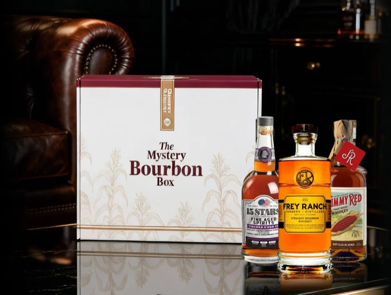 The Mystery Bourbon Box beside three bottles
