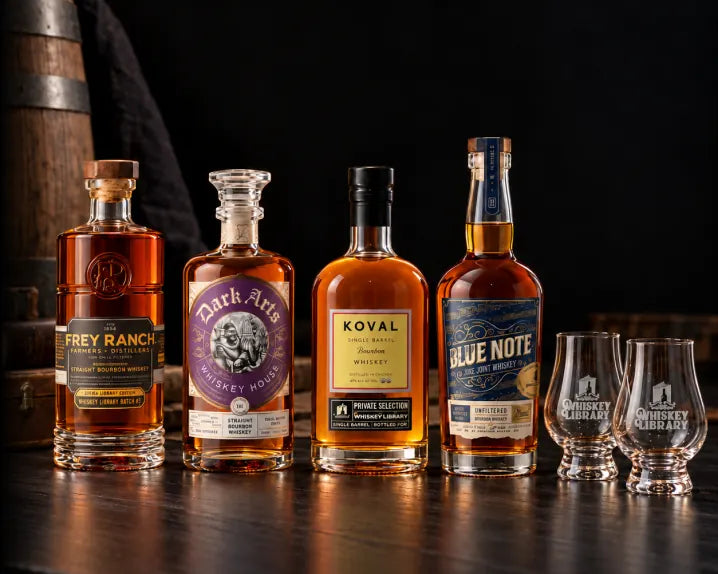 A Whiskey Library Mystery Box with bourbon bottles and glasses